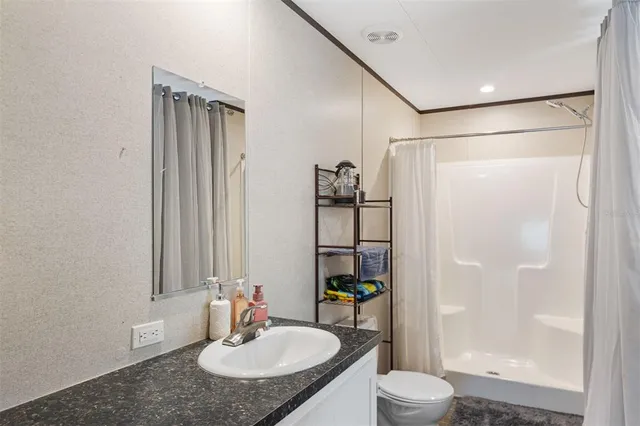 a bathroom with a sink toilet and shower