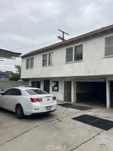 231 West 88th Street Los Angeles, CA 90003 - Photo 12 of 15 a front view of a house with parking space