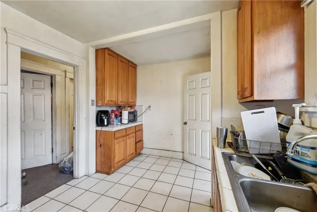 a kitchen with a sink and wooden cabinets