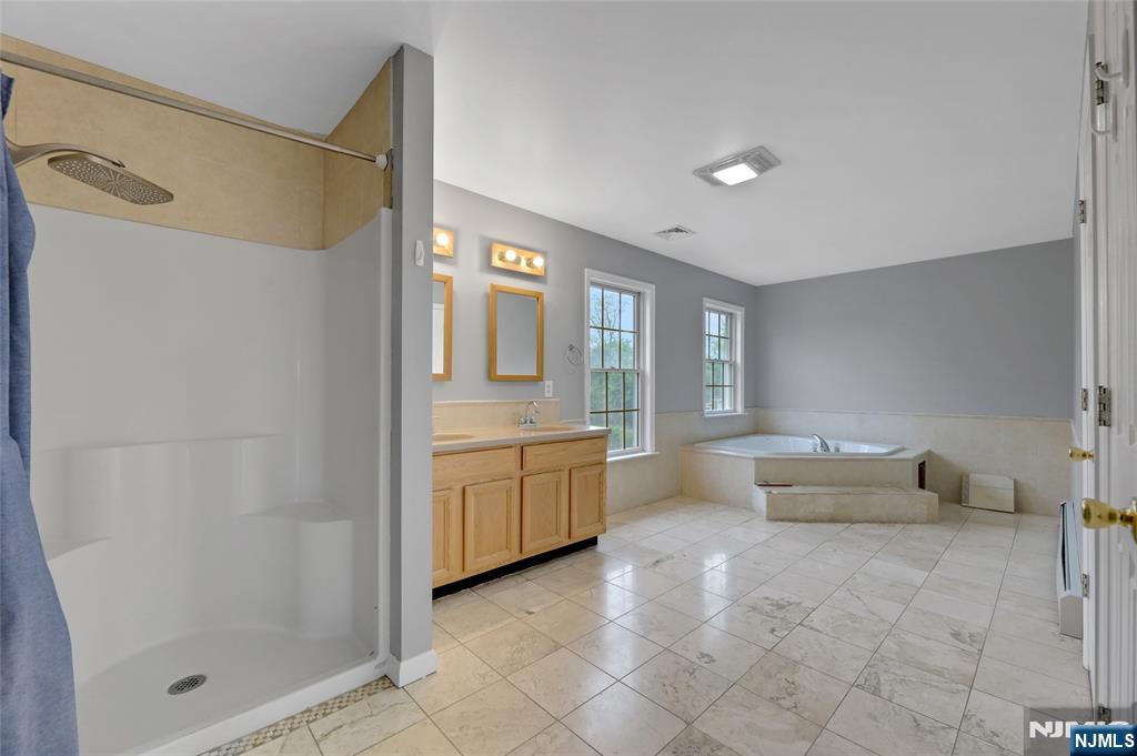 40 Horseneck Road Montville, NJ 07045 - Photo 13 of 47 a spacious bathroom with a tub shower and mirror
