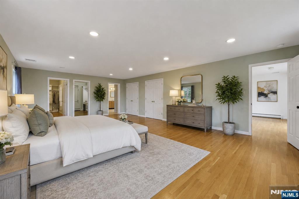 40 Horseneck Road Montville, NJ 07045 - Photo 3 of 47 a bedroom with a large bed and wooden floor