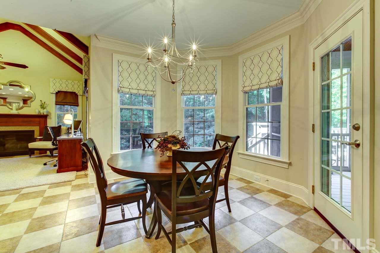 1420 Wynncrest Court Raleigh, NC 27603 - Photo 11 of 30 a dining room with furniture a chandelier and wooden floor