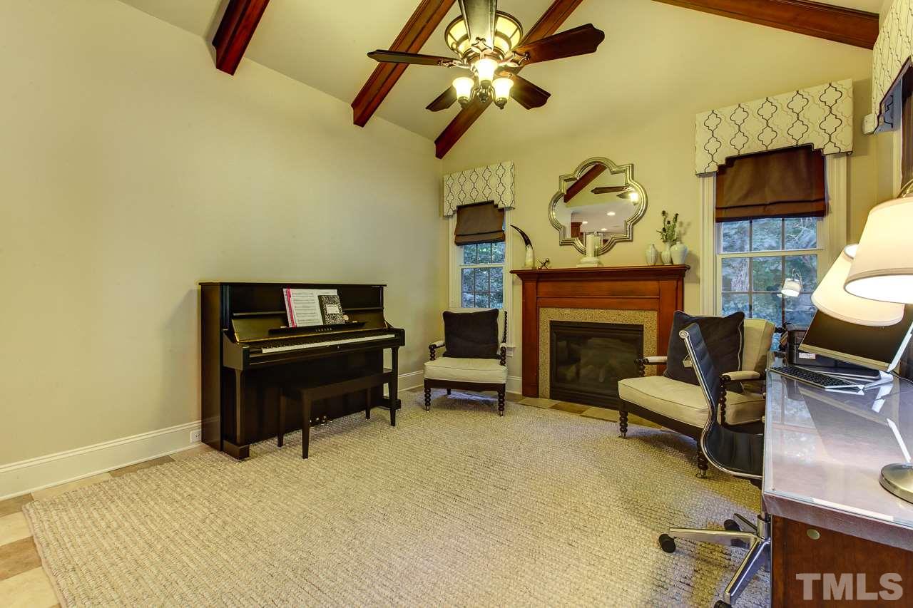 1420 Wynncrest Court Raleigh, NC 27603 - Photo 13 of 30 a living room with furniture a fireplace and a flat screen tv