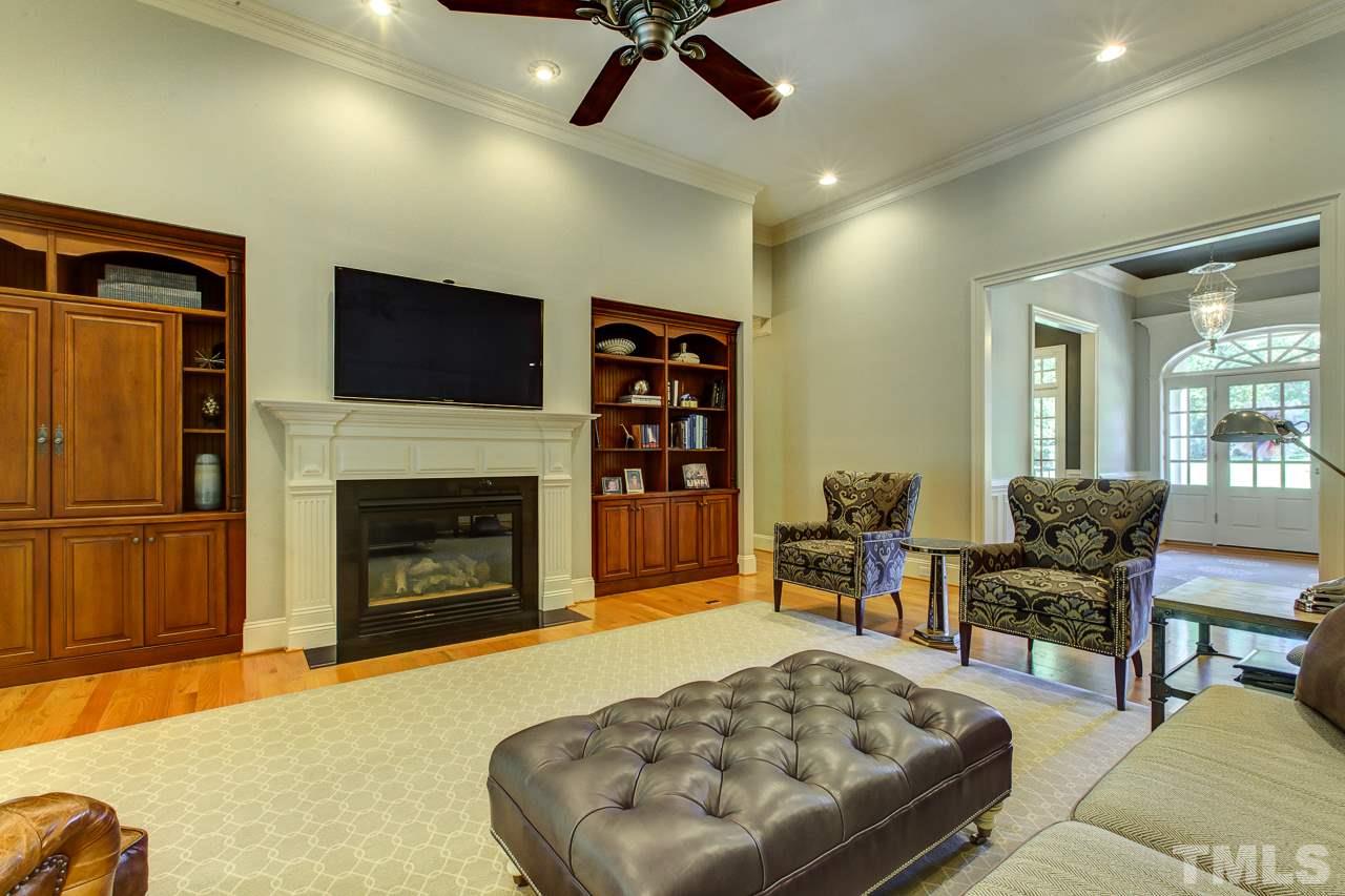 1420 Wynncrest Court Raleigh, NC 27603 - Photo 16 of 30 a living room with furniture and a fireplace