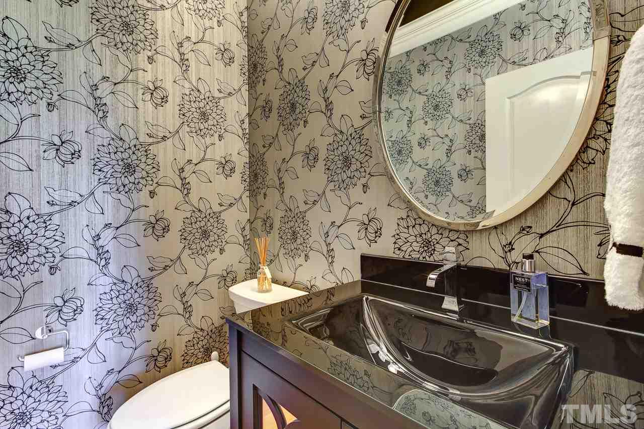 1420 Wynncrest Court Raleigh, NC 27603 - Photo 17 of 30 a bathroom with a sink a toilet and mirror