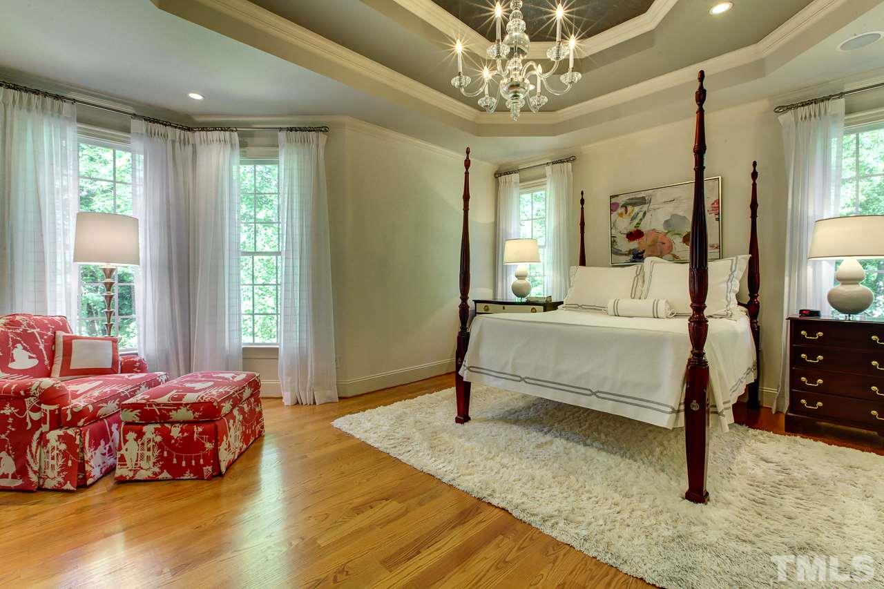 1420 Wynncrest Court Raleigh, NC 27603 - Photo 18 of 30 a bedroom with a bed wooden floor and window