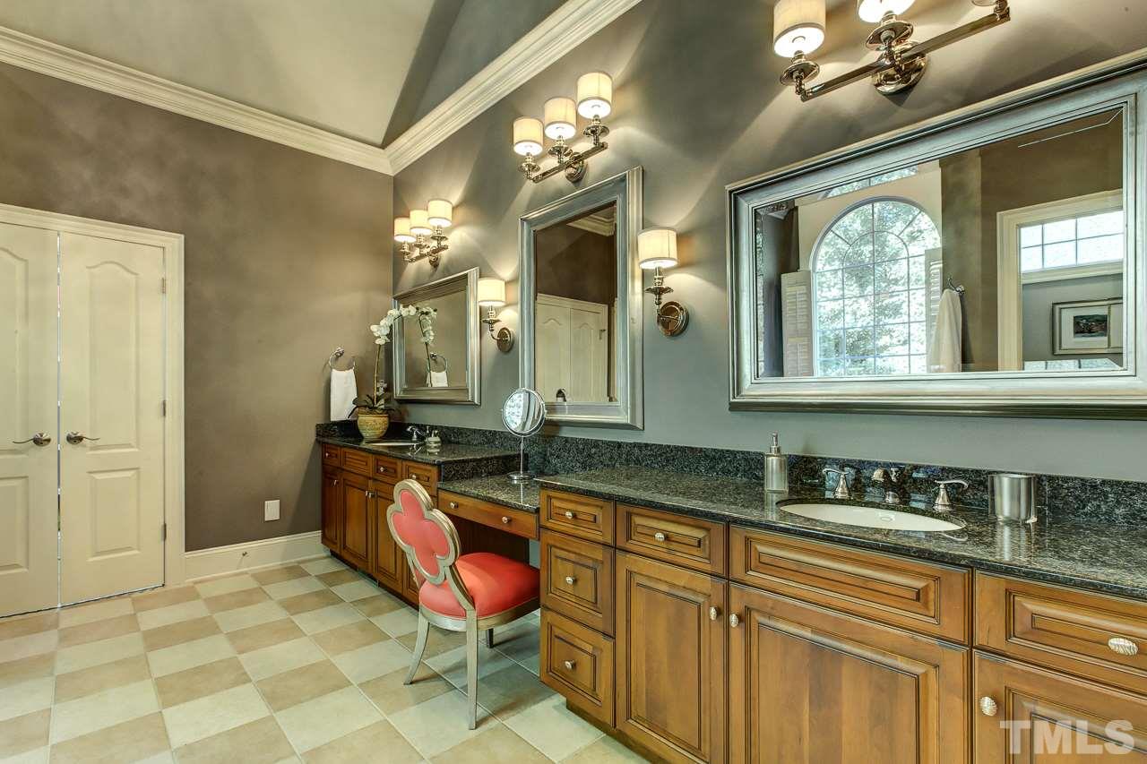 1420 Wynncrest Court Raleigh, NC 27603 - Photo 20 of 30 a bathroom with a granite countertop sink a toilet a mirror and vanity