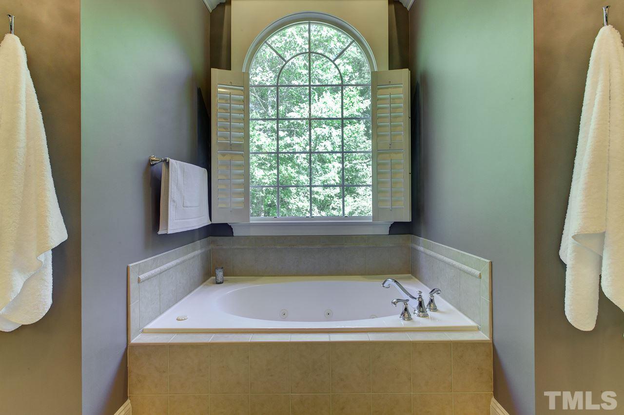 1420 Wynncrest Court Raleigh, NC 27603 - Photo 21 of 30 a bath tub sitting next to a window