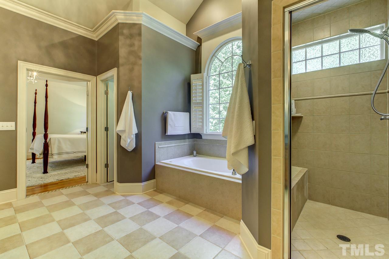 1420 Wynncrest Court Raleigh, NC 27603 - Photo 22 of 30 a bathroom with a tub and shower