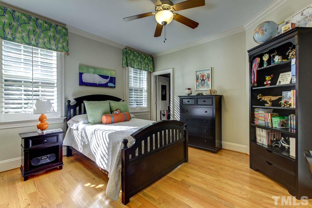 1420 Wynncrest Court Raleigh, NC 27603 - Photo 23 of 30 a bedroom with bed and a chandelier