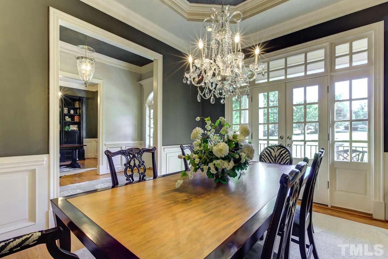 1420 Wynncrest Court Raleigh, NC 27603 - Photo 5 of 30 a dining room with furniture a chandelier and wooden floor