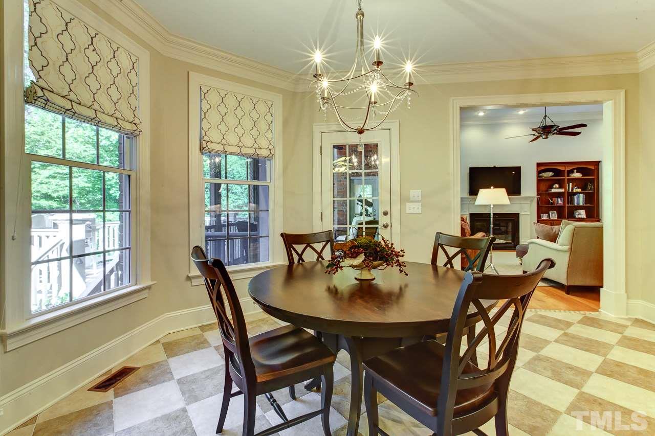 1420 Wynncrest Court Raleigh, NC 27603 - Photo 10 of 30 a view of a dining room with furniture wooden floor and chandelier