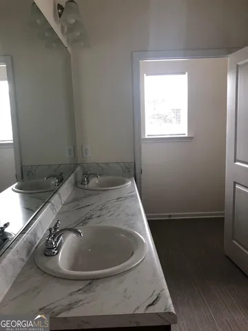 a bathroom with a bathtub and a window
