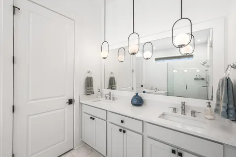 a bathroom with a double vanity sink and mirror