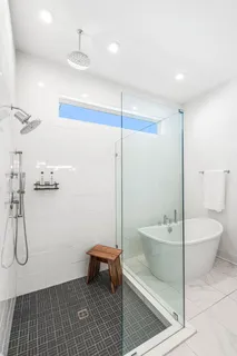 a bathroom with a toilet a sink and a shower