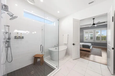 a spacious bathroom with a shower a toilet and a sink