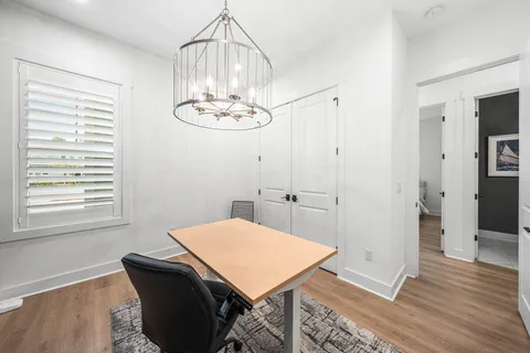 a view of a dining room with a table chairs and wooden floor