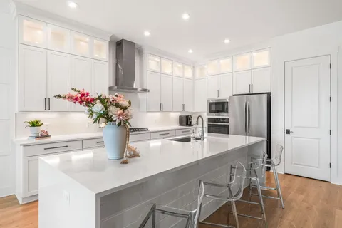 a kitchen with stainless steel appliances a sink and a refrigerator