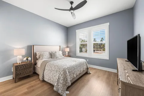 a bedroom with a bed tv and window