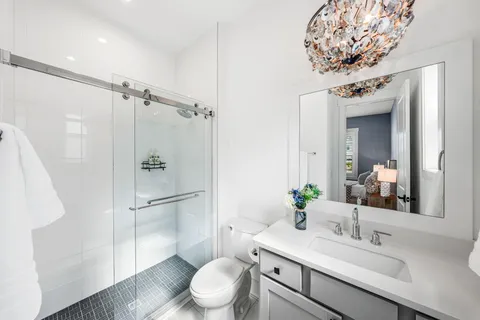 a bathroom with a sink toilet and shower