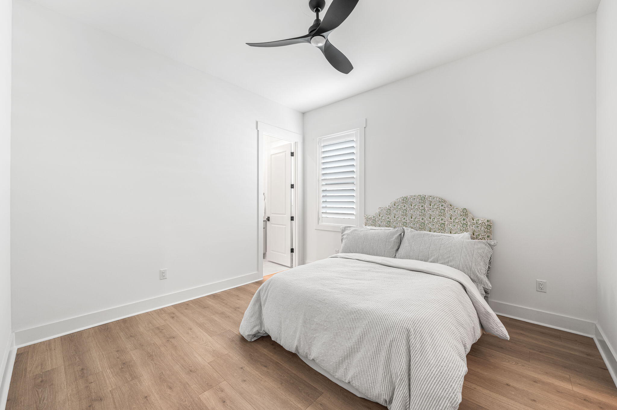 425 Lafayette Road Watersound, FL 32461 - Photo 34 of 52 a bedroom with a bed and wooden floor