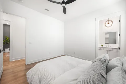 a bedroom with a bed and wooden floor