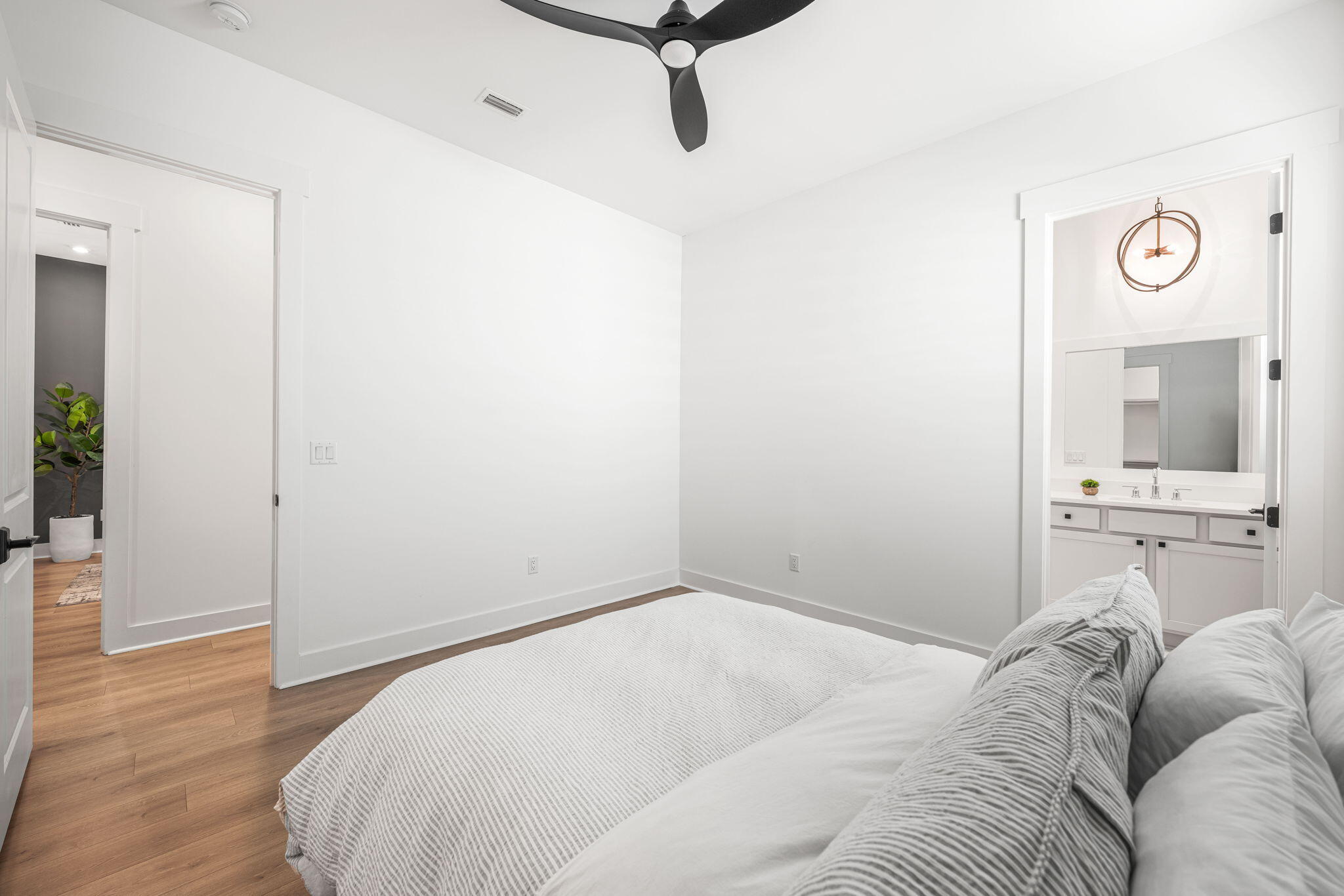 425 Lafayette Road Watersound, FL 32461 - Photo 35 of 52 a bedroom with a bed and wooden floor