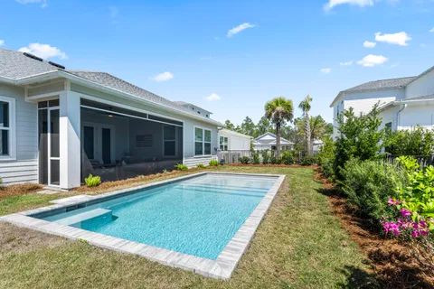 a view of a house with swimming pool and sitting area