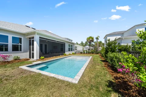 a view of a swimming pool with an outdoor seating and a garden