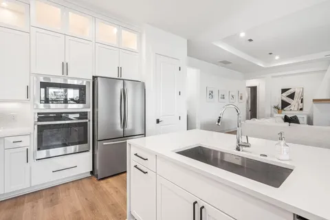 a kitchen with a sink cabinets and stainless steel appliances