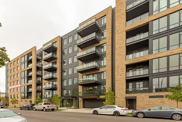 a living room with furniture a large window and a flat screen tv