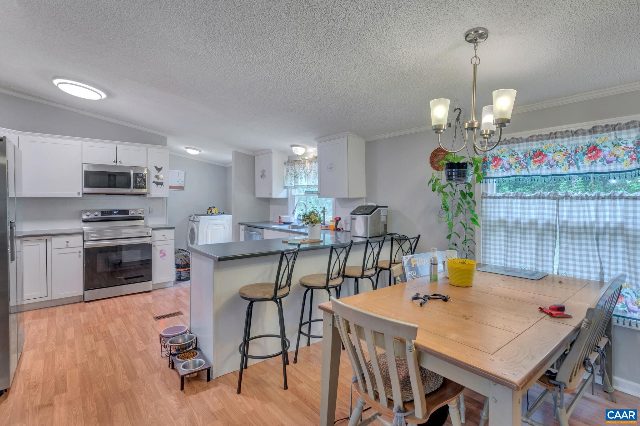 1826 Adial Road Faber, VA 22938 - Photo 14 of 39 a view of a dining room with furniture and wooden floor