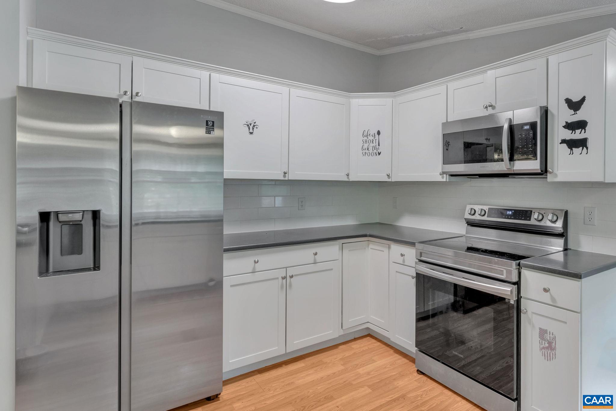 1826 Adial Road Faber, VA 22938 - Photo 16 of 39 a kitchen with stainless steel appliances granite countertop a refrigerator a stove and white cabinets