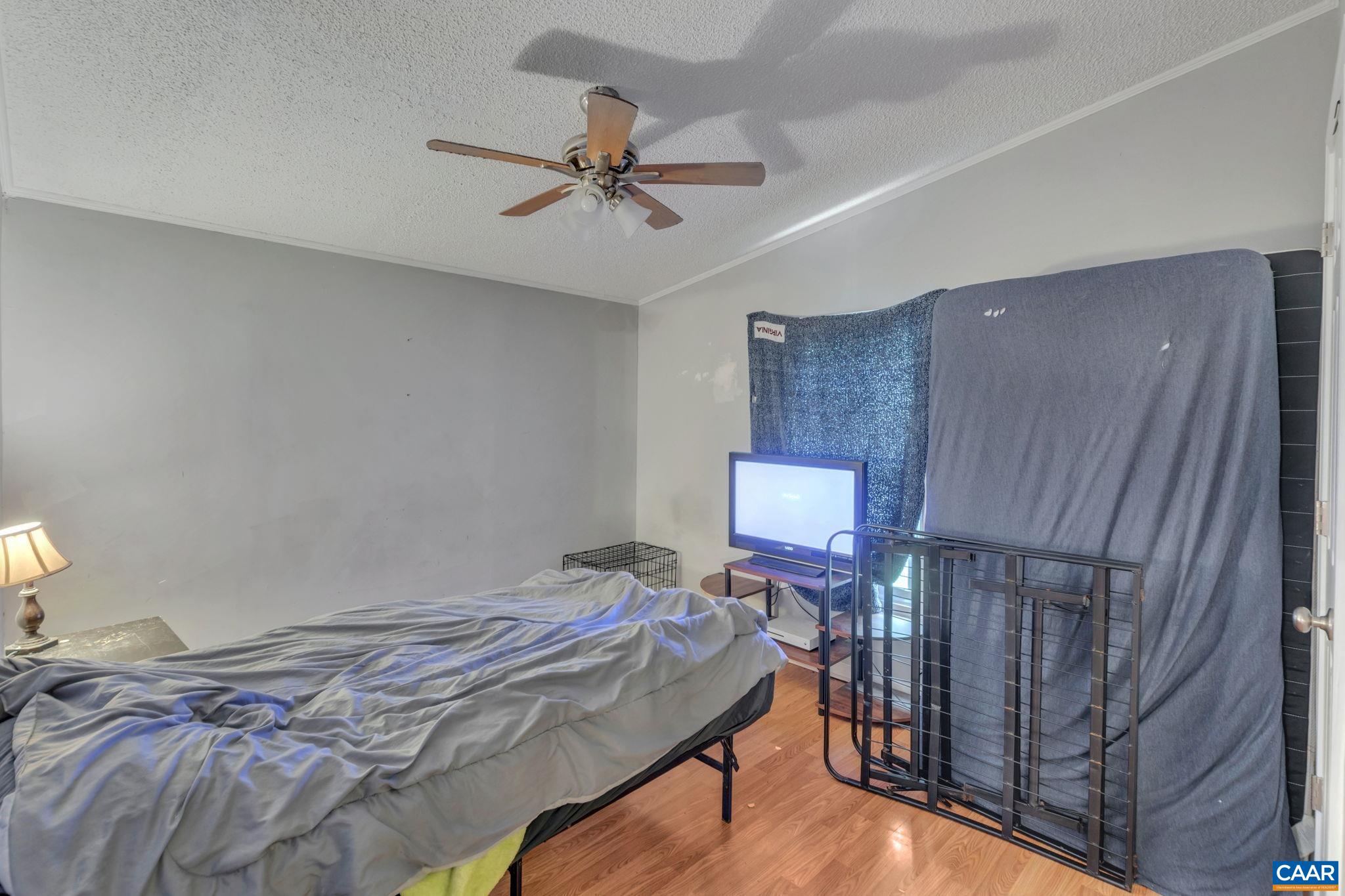 1826 Adial Road Faber, VA 22938 - Photo 23 of 39 a bed sitting in a room next to a wooden cabinet