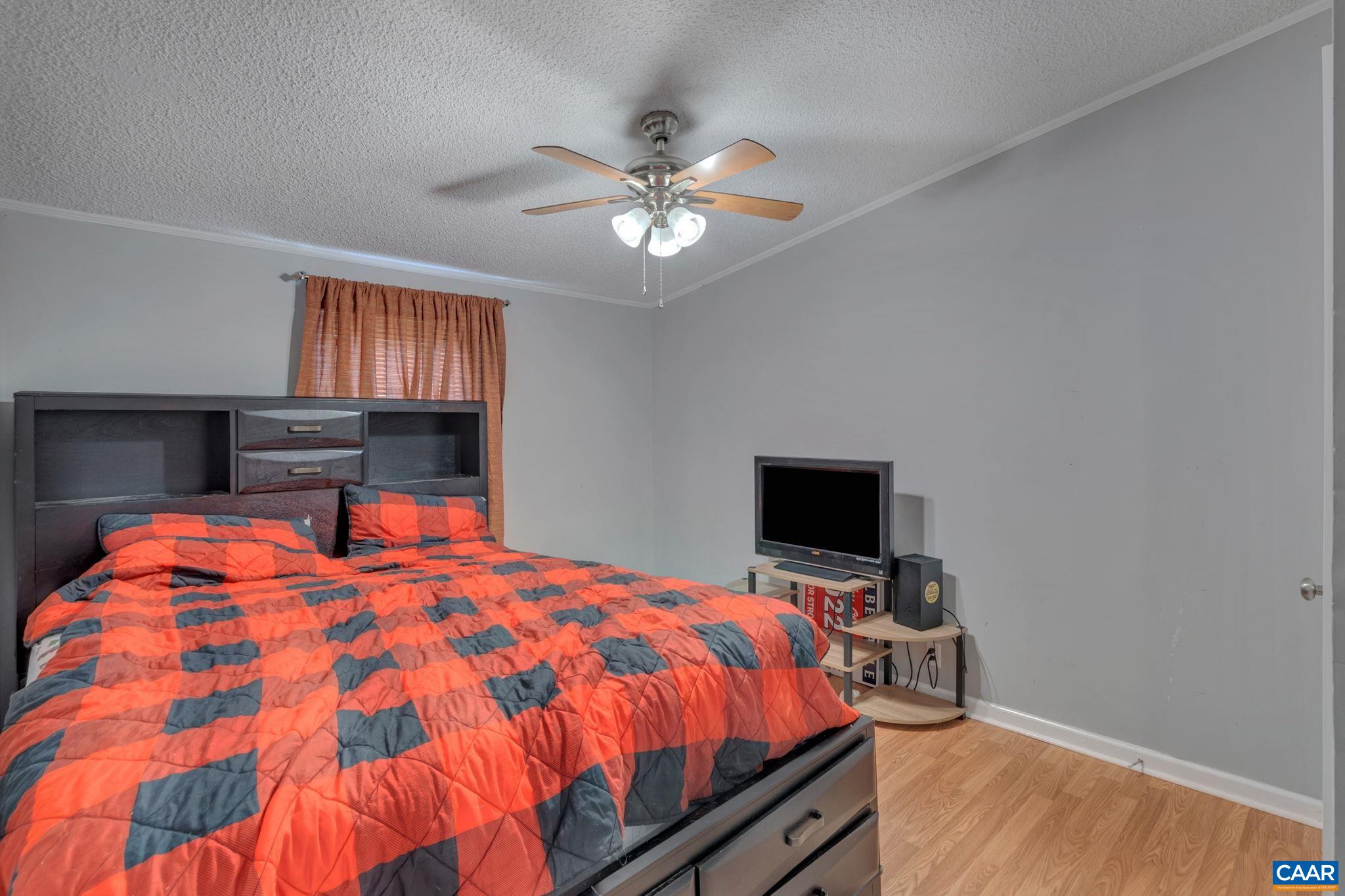 1826 Adial Road Faber, VA 22938 - Photo 24 of 39 a bed sitting in a bedroom and a flat screen tv