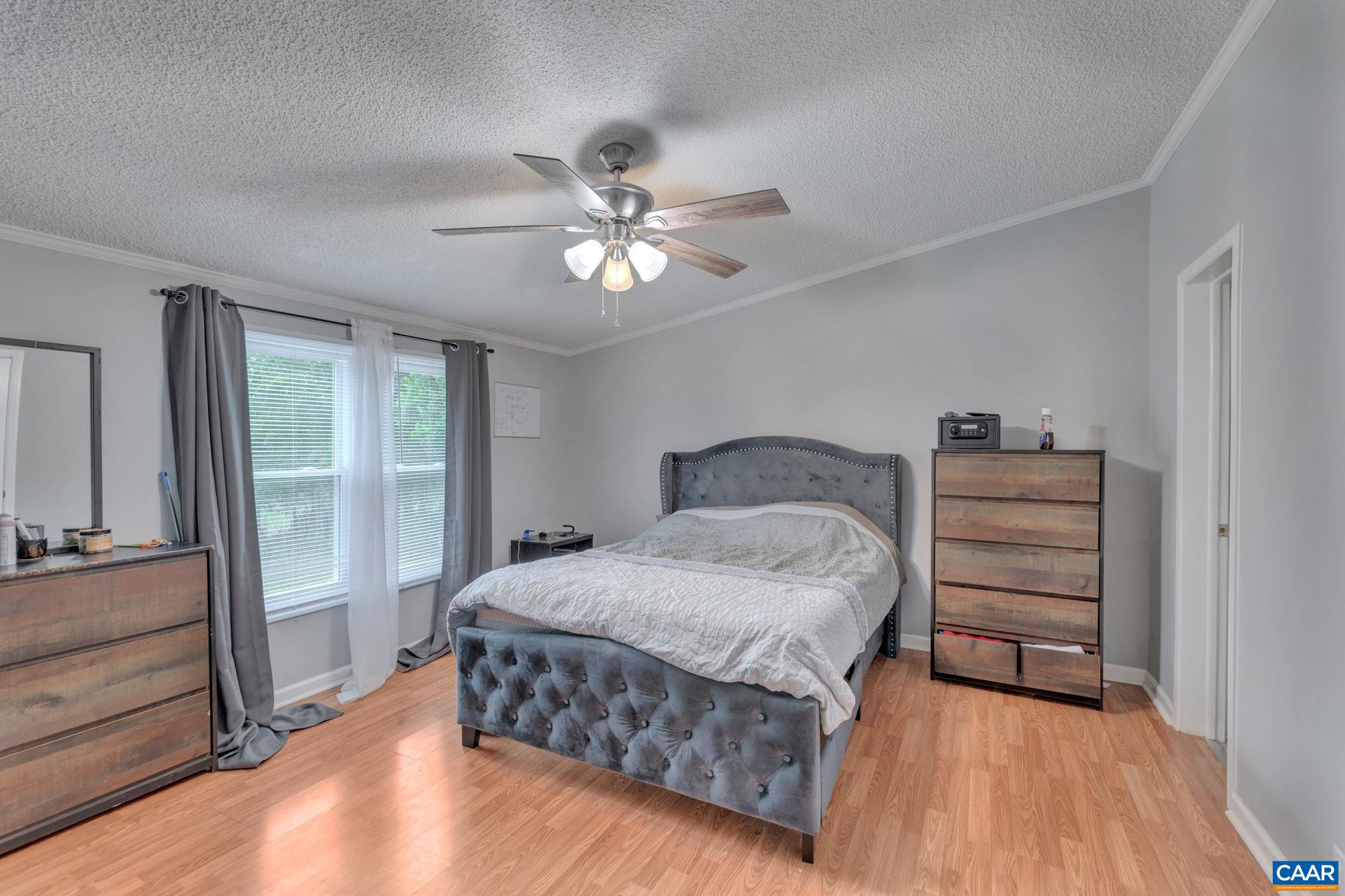 1826 Adial Road Faber, VA 22938 - Photo 7 of 39 a bedroom with a bed and a chandelier