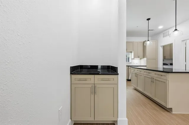 a kitchen with a refrigerator and a sink