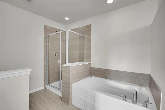 a bathroom with a bathtub and a shower