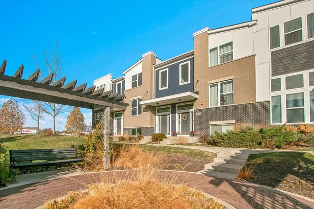 a front view of a building with a garden