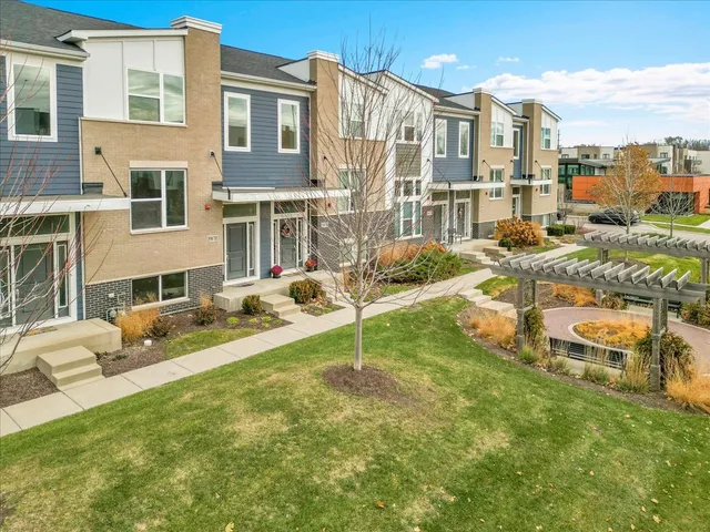 a view of a house with a backyard and a patio