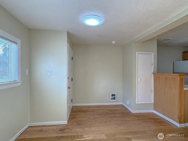 wooden floor in a hall with an entryway and a living room