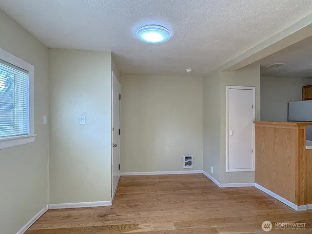 wooden floor in a hall with an entryway and a living room
