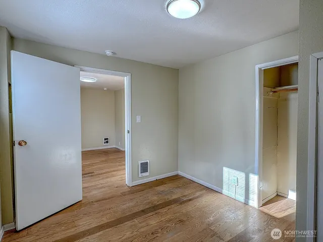 a room with closet and wooden floor