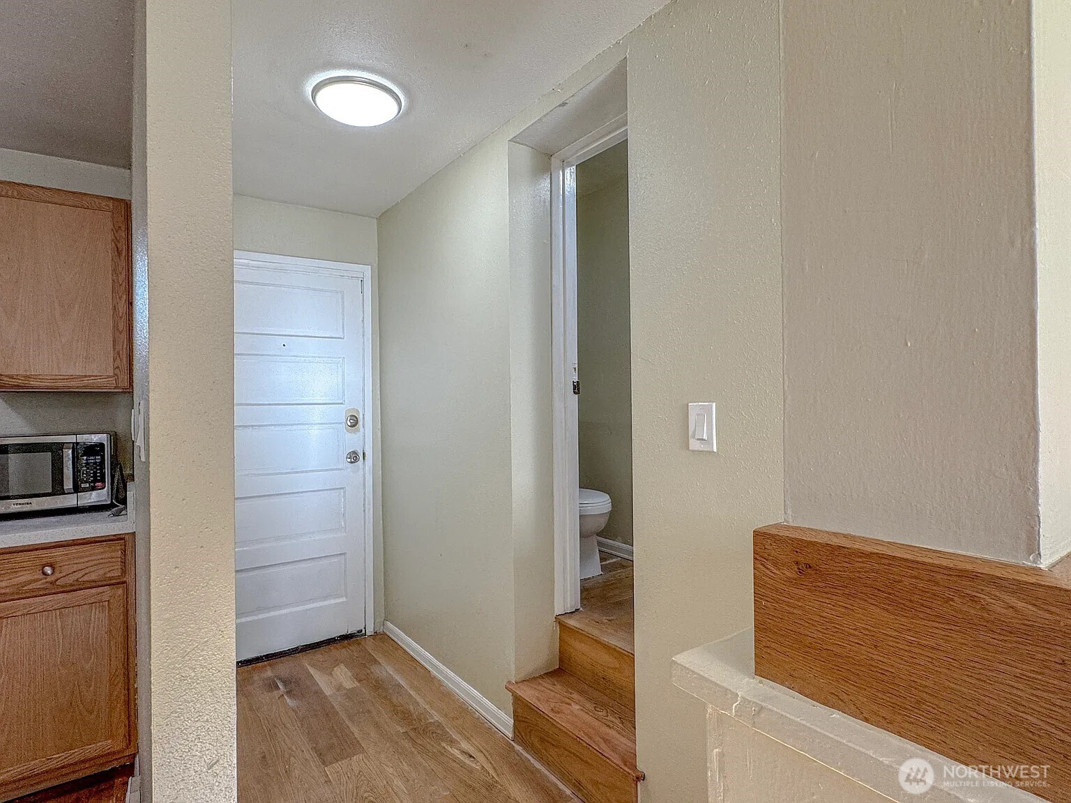 7103 Linden Avenue North, Unit 15 Seattle, WA 98103 - Photo 21 of 40 a room with closet and wooden floor
