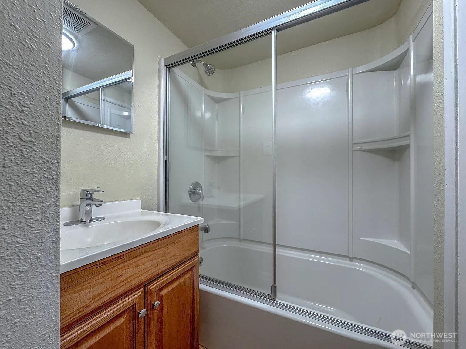 7103 Linden Avenue North, Unit 15 Seattle, WA 98103 - Photo 22 of 40 a bathroom with a sink and a mirror