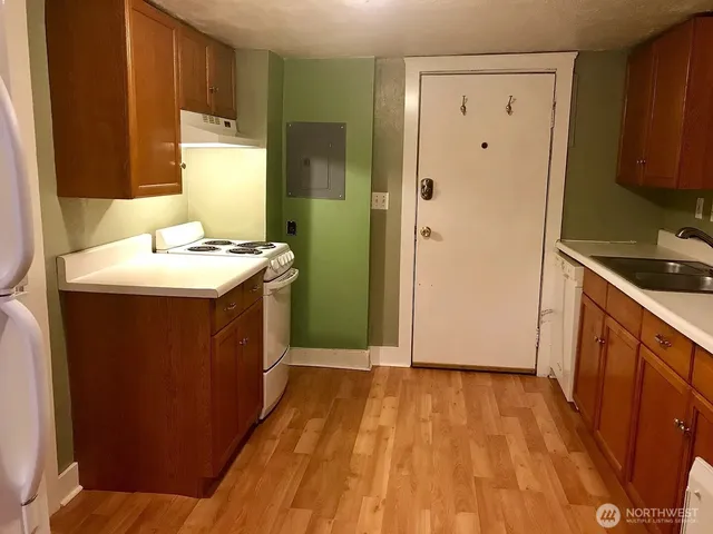 a view of a room with wooden floor and a window