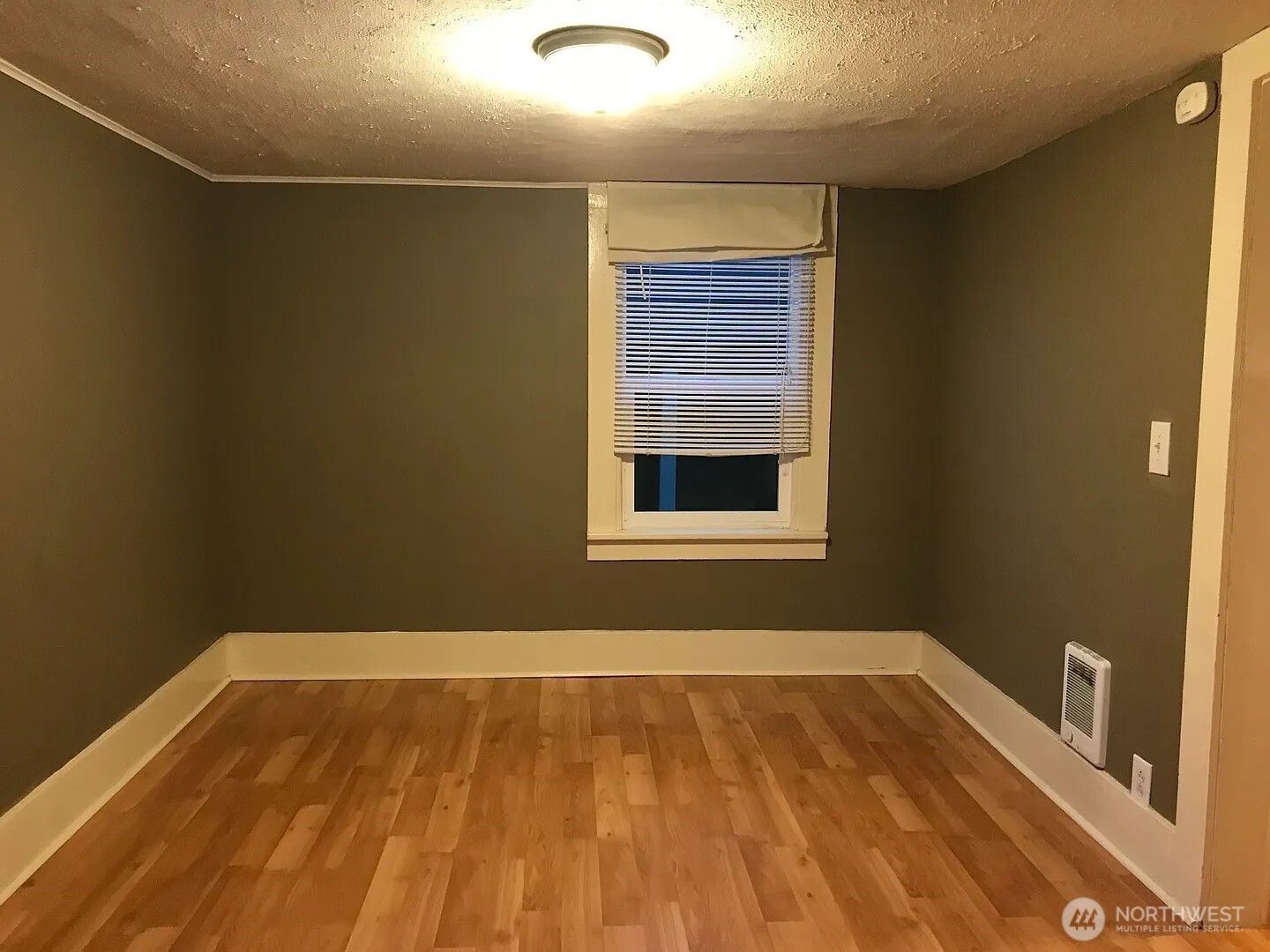 7103 Linden Avenue North, Unit 15 Seattle, WA 98103 - Photo 24 of 40 a view of a room with wooden floor and a window