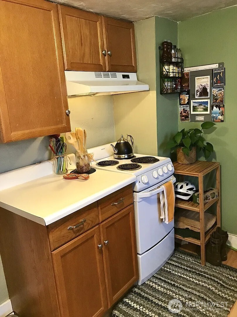 7103 Linden Avenue North, Unit 15 Seattle, WA 98103 - Photo 27 of 40 a kitchen with a stove and a sink