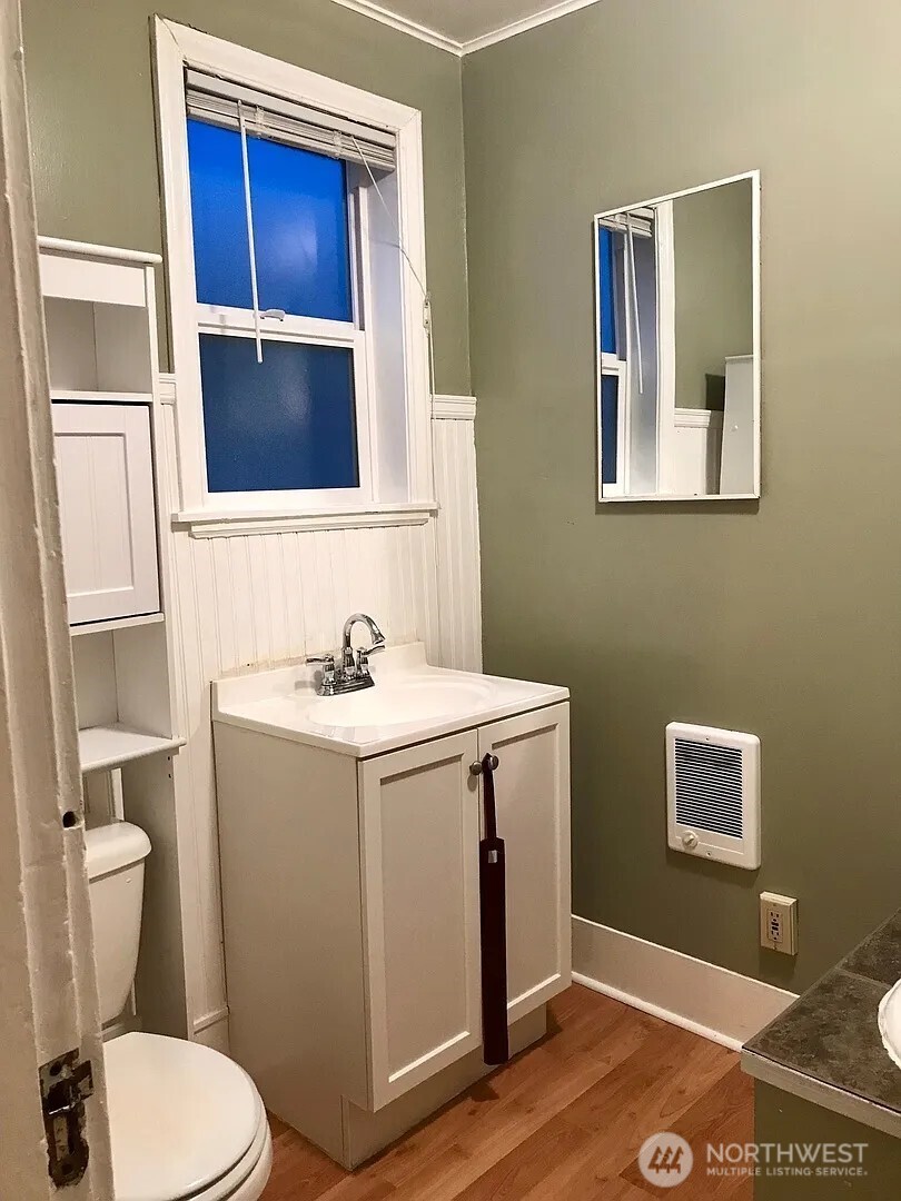 7103 Linden Avenue North, Unit 15 Seattle, WA 98103 - Photo 30 of 40 a bathroom with a toilet sink and mirror
