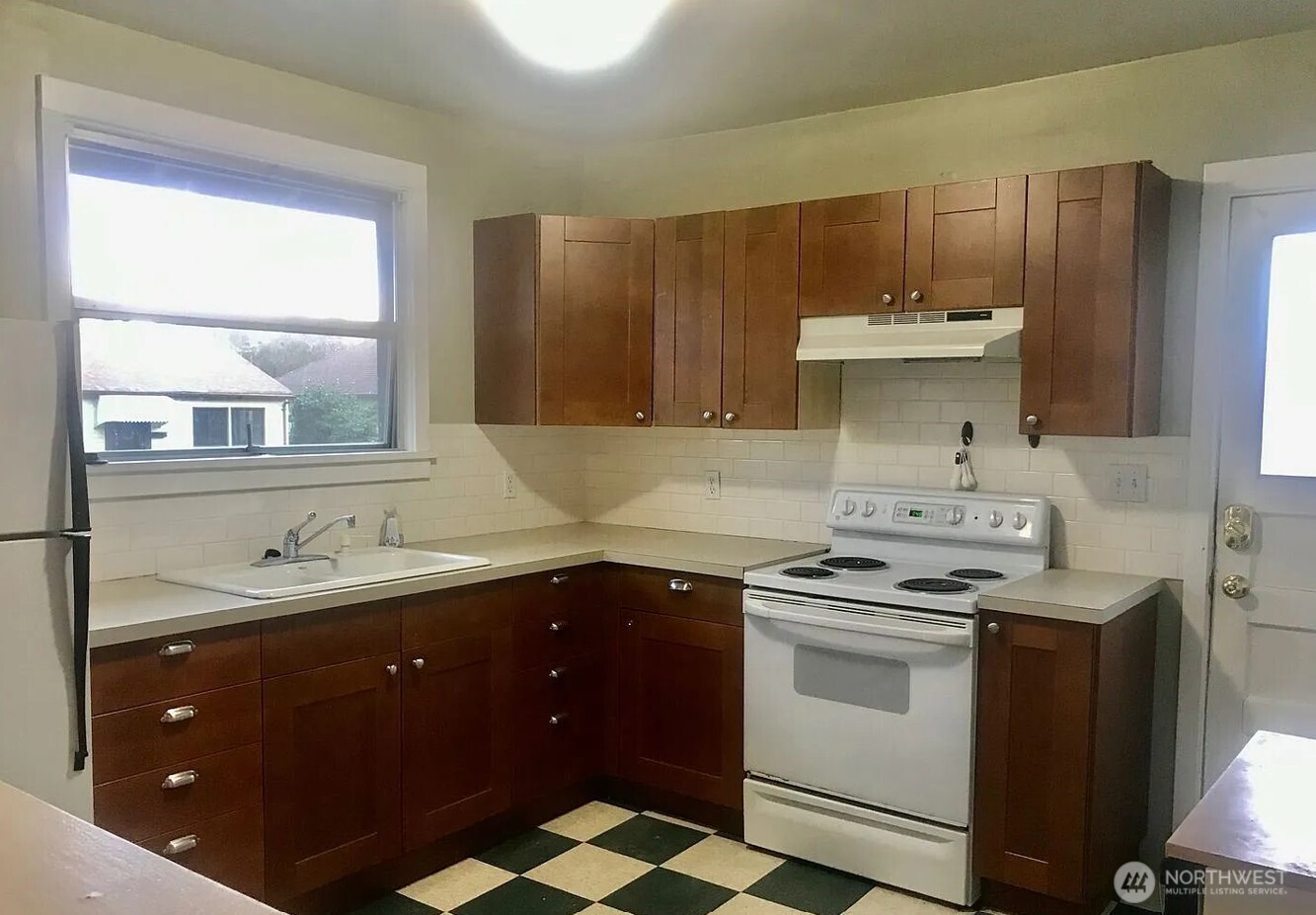 7103 Linden Avenue North, Unit 15 Seattle, WA 98103 - Photo 35 of 40 a kitchen with a sink stove and cabinets